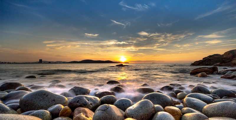 Stone beach overlooking a sunset